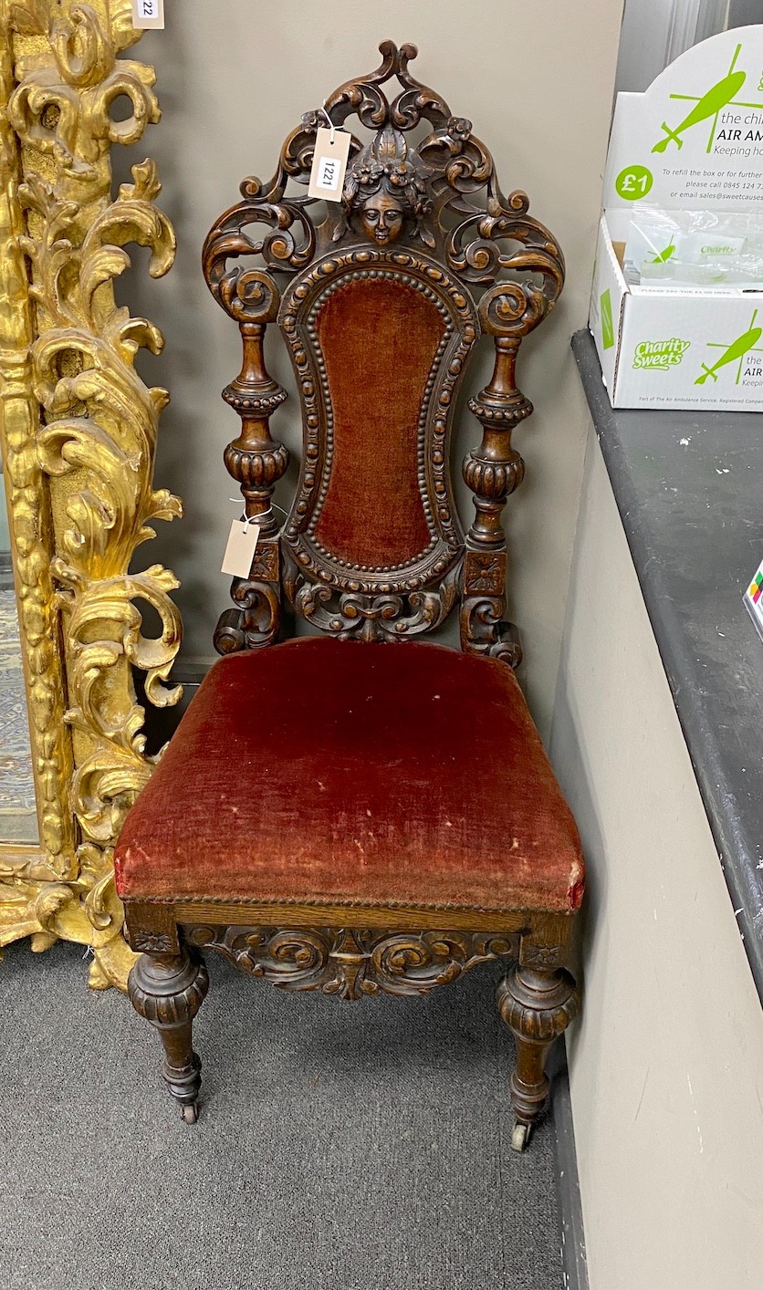 A pair of 19th century Flemish carved oak side chairs, height 118cm